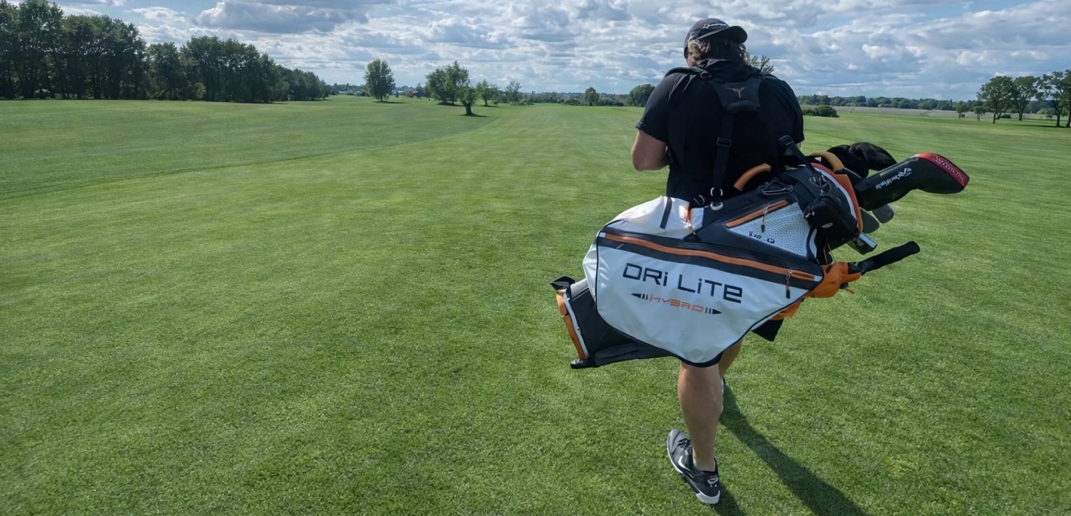 Ian walking a fairway with golf bag